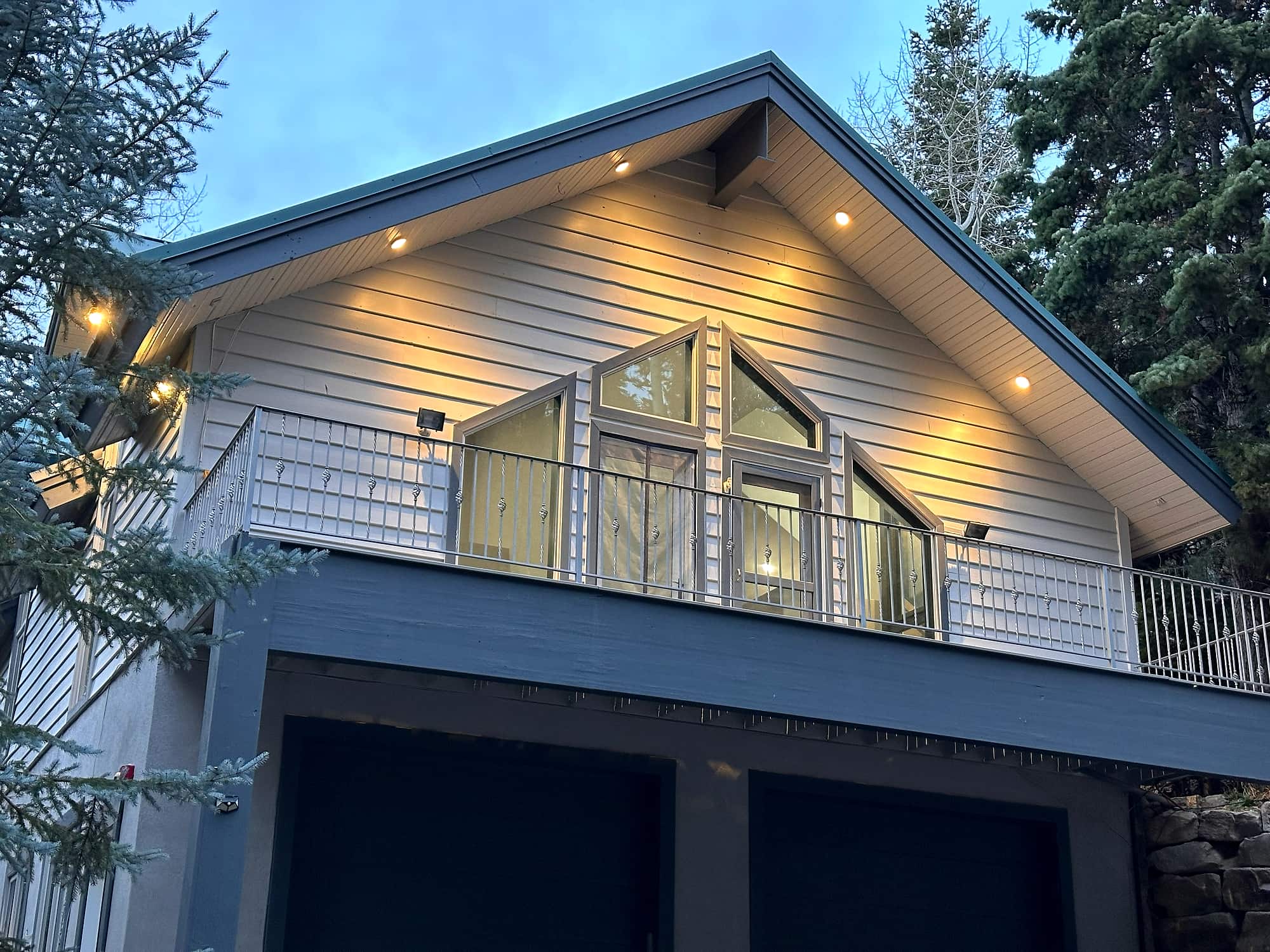 The residence at dusk with the eaves lit