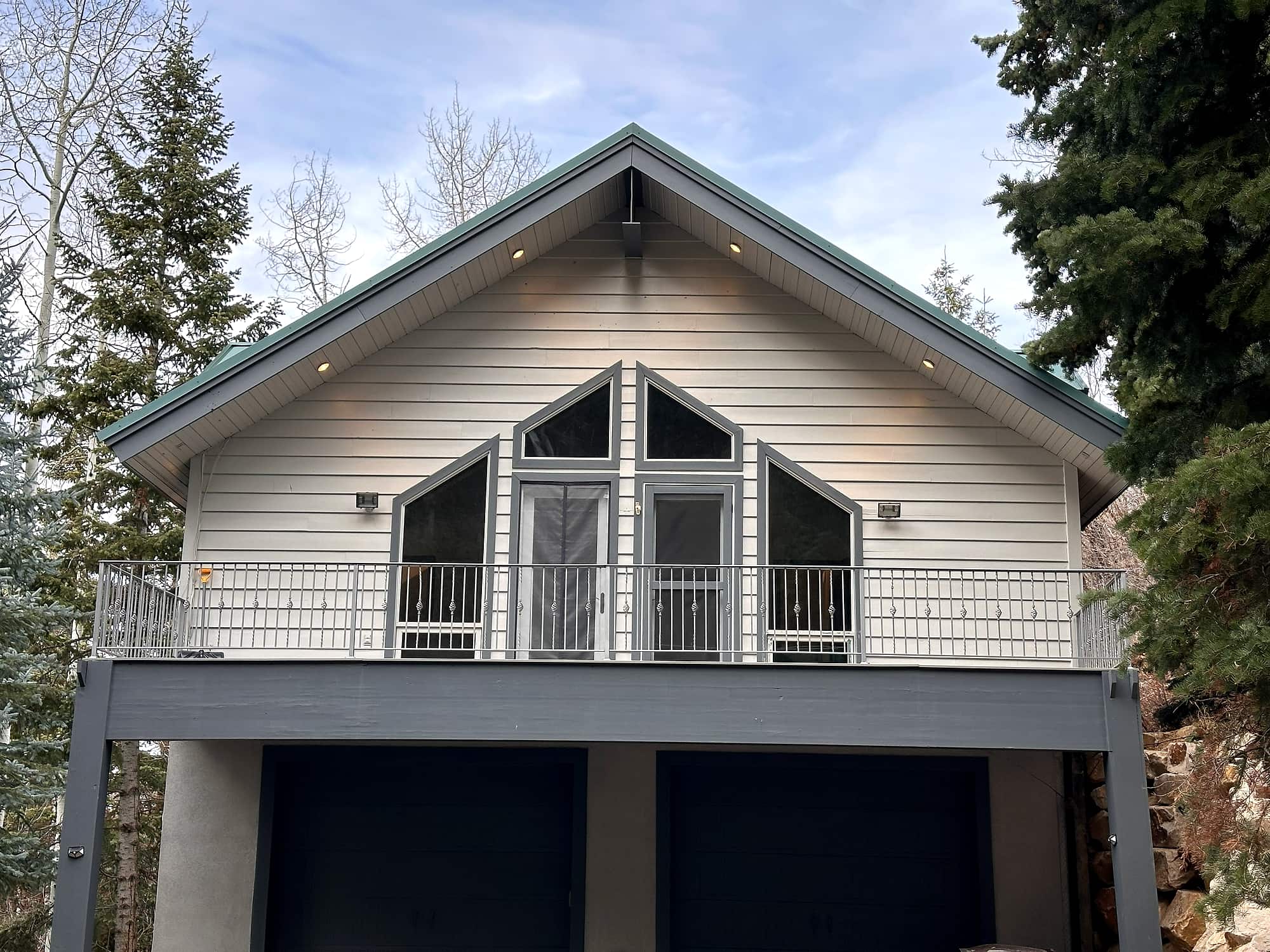 The residence seen head-on, deck across the gable